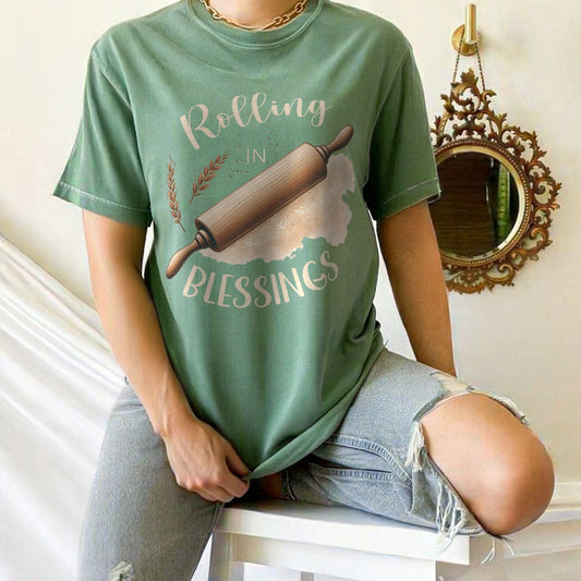 Person wearing a green t-shirt with 'Rolling in Blessings' graphic design.